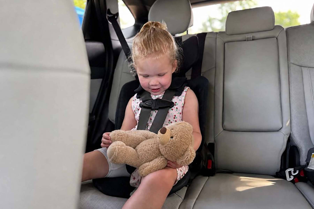 toddler strapped into a WAYB Pico car seat in a rental car