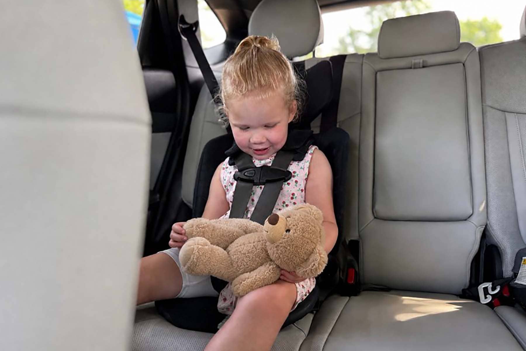 toddler strapped into a WAYB Pico car seat in a rental car