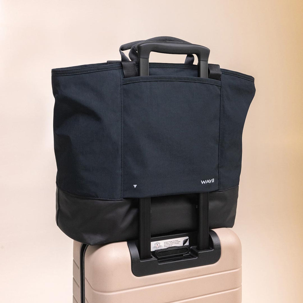The Toddler Tote attached to a suitcase