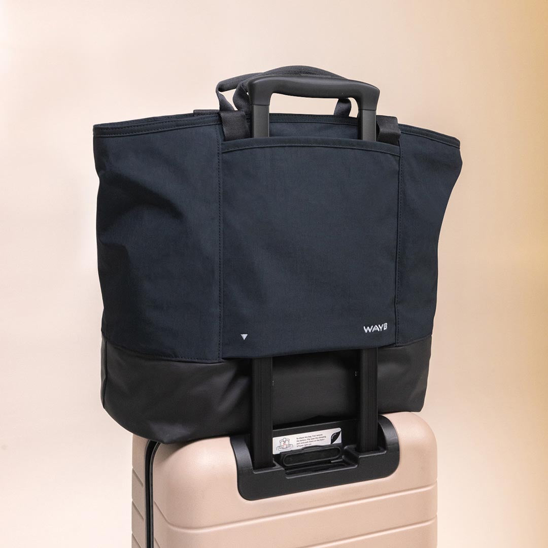 The Toddler Tote attached to a suitcase