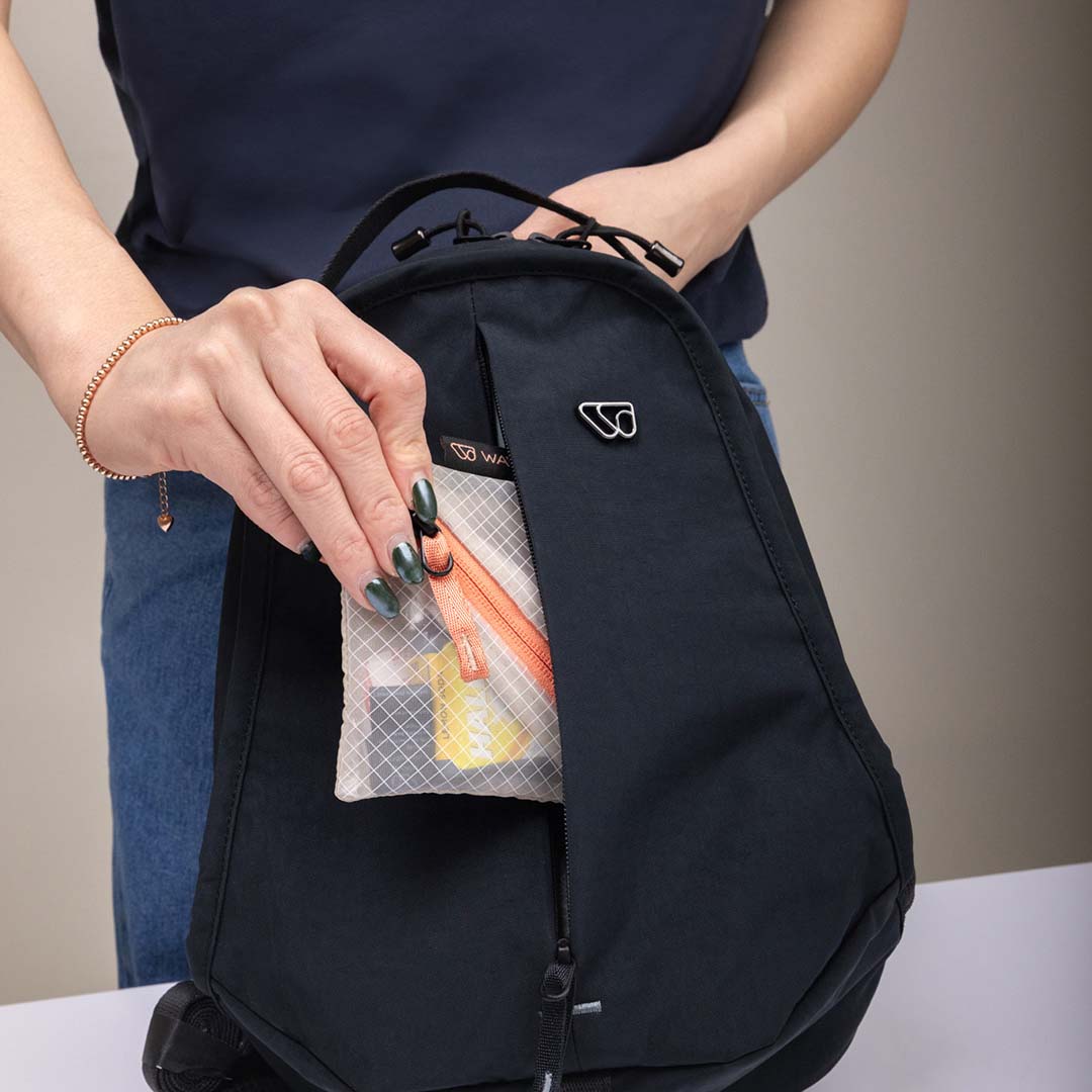 The Sling Bag's front pocket featuring The Essentials Kit