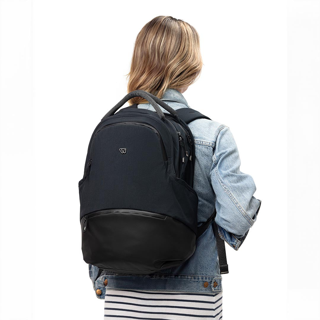 Person carrying The Daily Pack in black