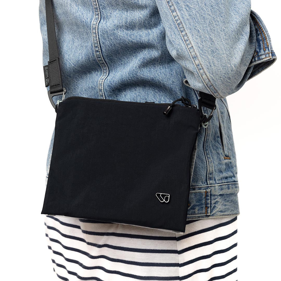 Person carrying The Crossbody Kit in black