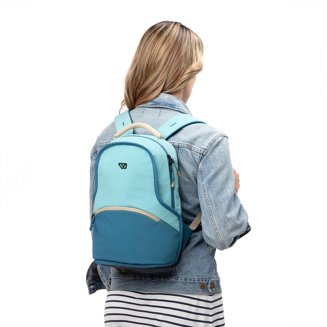 Woman carrying 15L Mini Pack in light blue