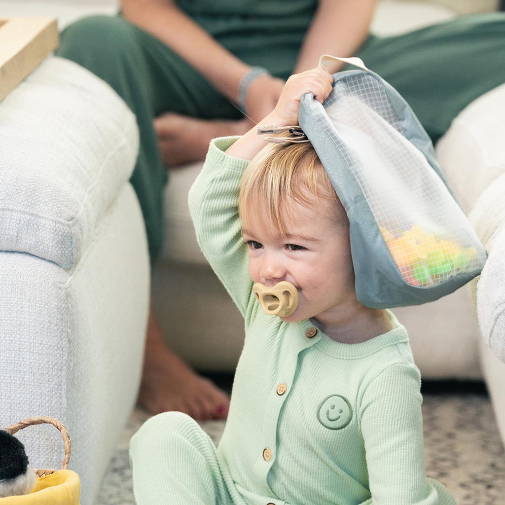 Toddler holding the WAYB Pods