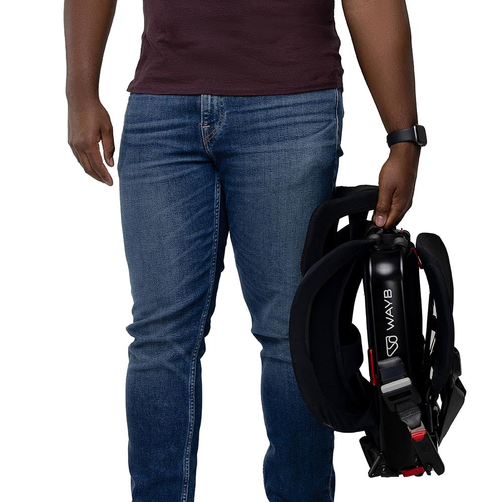 Parent carrying collapsed WAYB Pico Car Seat