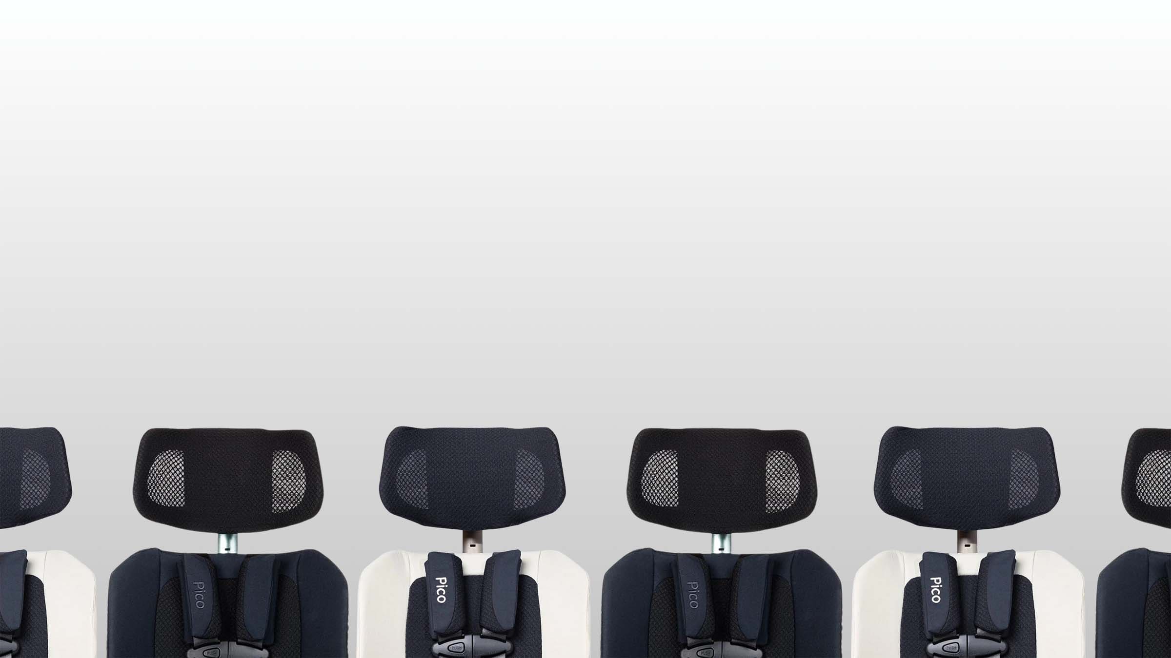 A row of infant car seats with black mesh headrests and white shells, arranged in a repeating horizontal pattern against a light gray background.