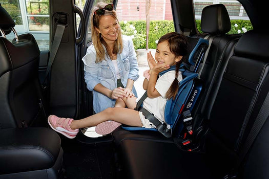Mom looking at her child in WAYB seat, both smiling.