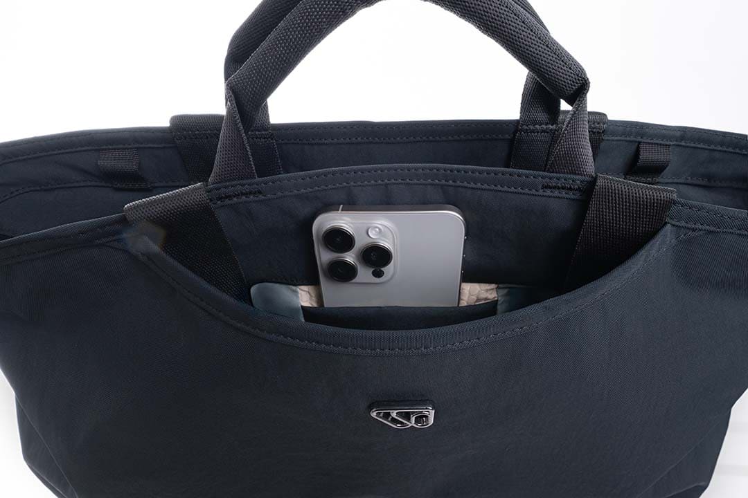 Black bag with a phone inside on a white background