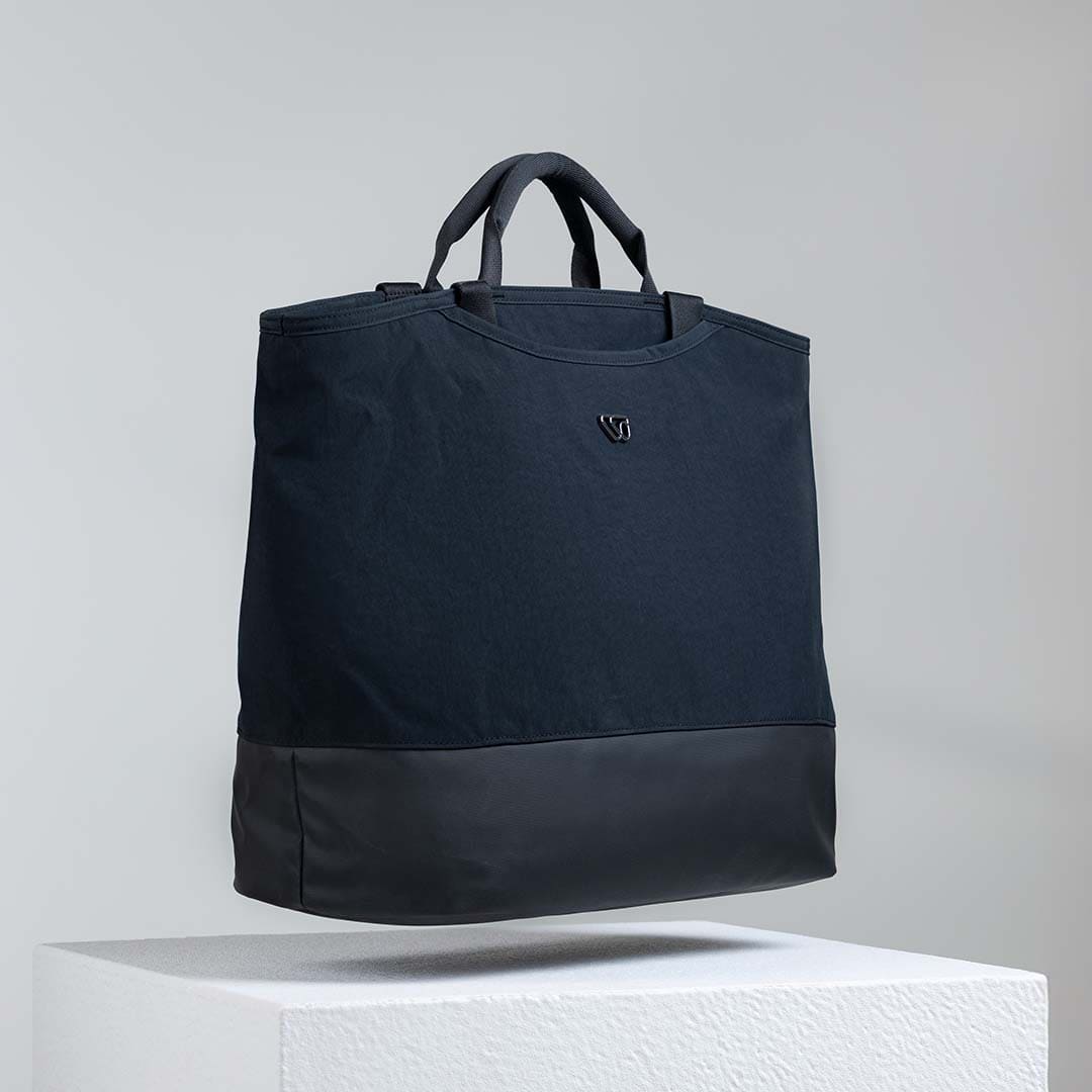 Black tote bag on a light gray background